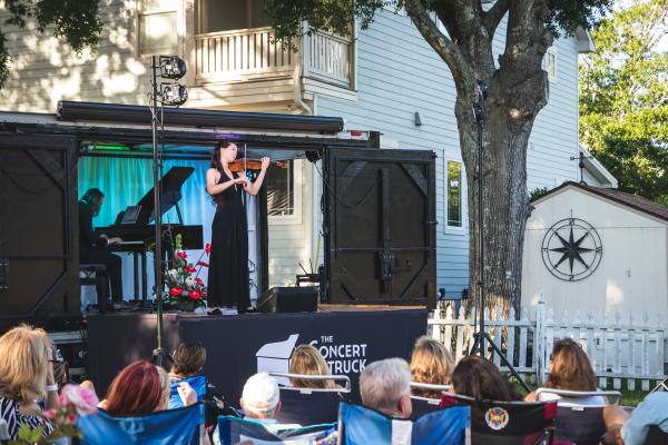 a violinist performing in front of an audience